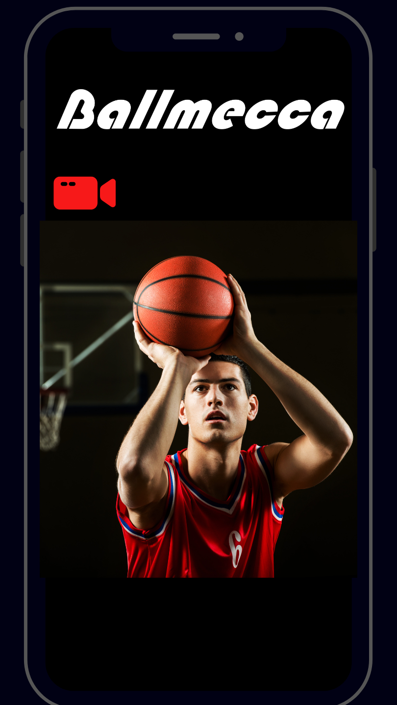 Basketball player demonstrating proper shooting form. Wearing a red shirt with a dark background behind his shooting pose and it appears to be in a basketball court. 
